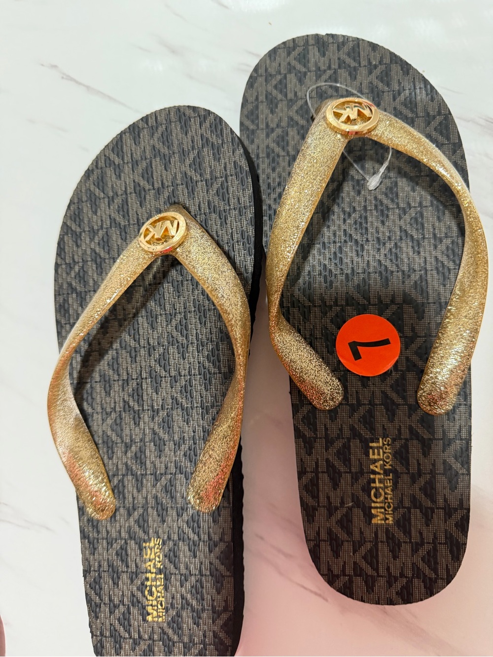 MICHAEL Michael Kors Black Monogram Flip Flops with Gold Glitter Straps